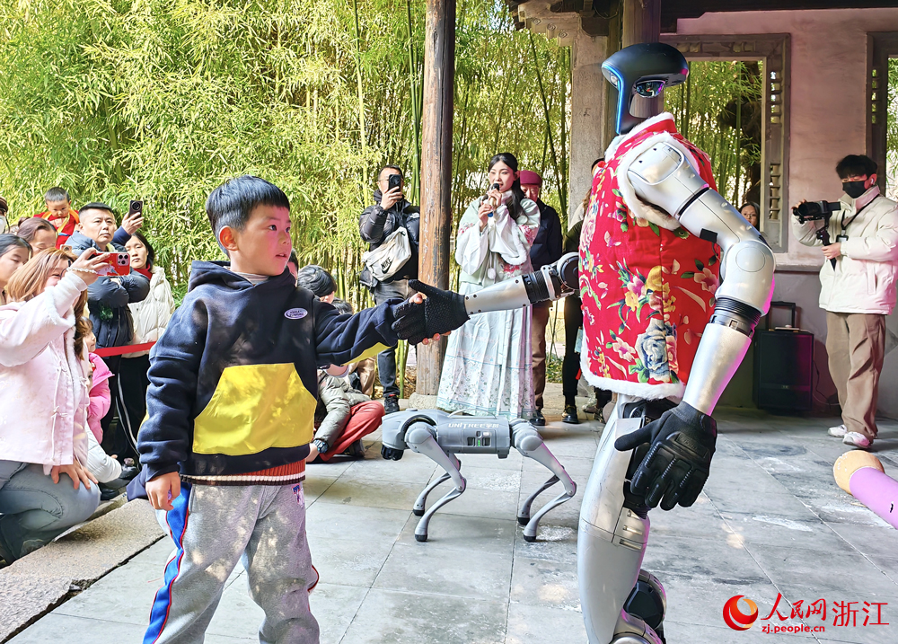 游客與機器人互動，體驗科技與傳統融合的獨特年味。人民網 方彭依夢攝