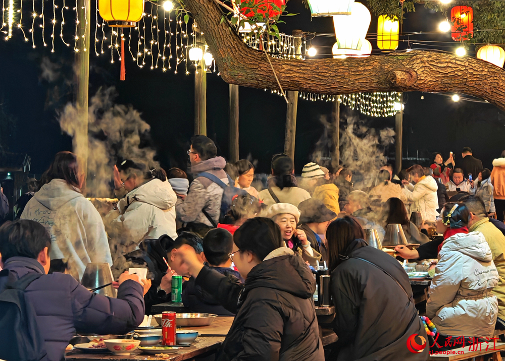 烏鎮的新春長街宴讓游客在水鄉風情中品嘗暖鍋等特色年味美食。人民網 方彭依夢攝